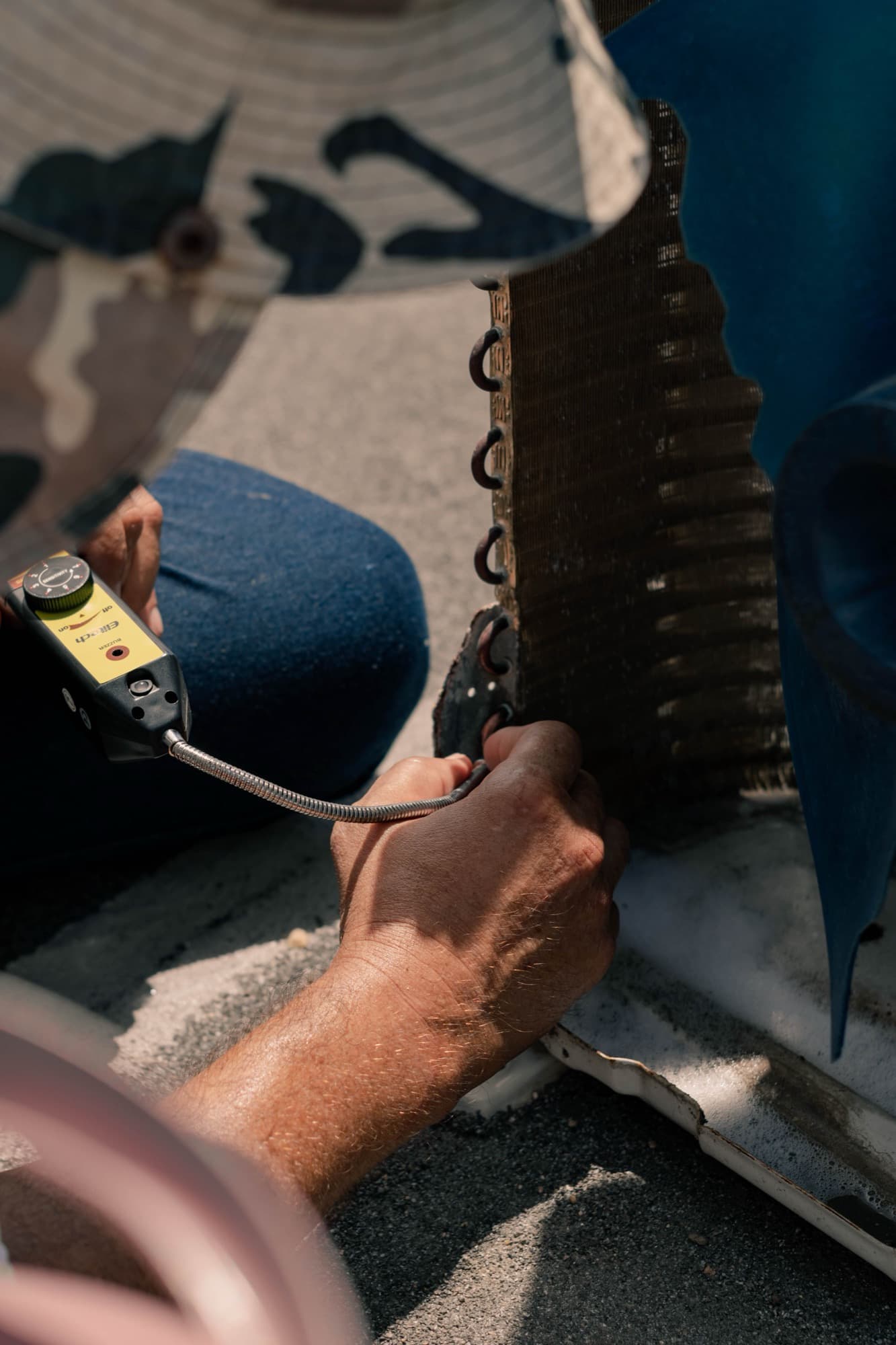 Technician testing an air conditioner coil