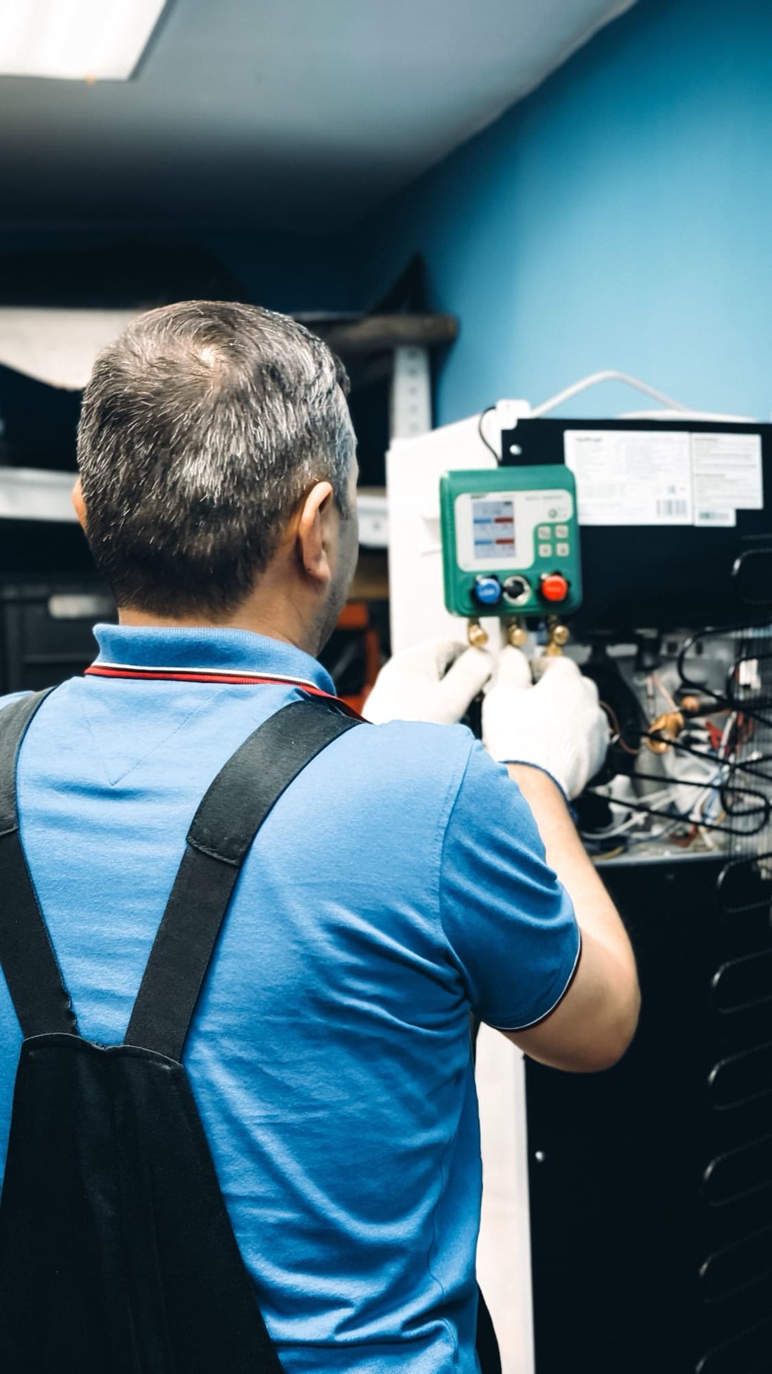 Technician servicing an indoor air conditioner