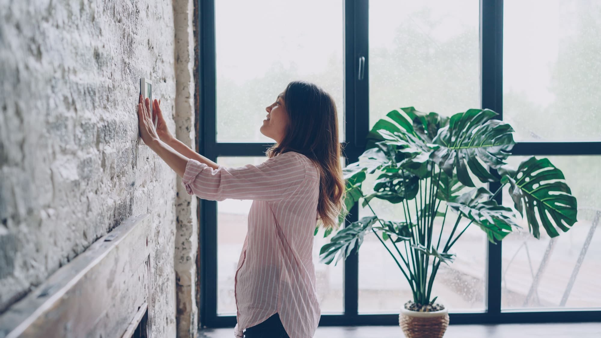 Homeowner adjusting a thermostat
